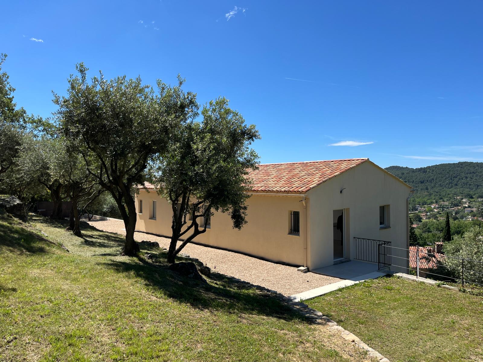 The villa and its stone annexe set in terraced olive groves